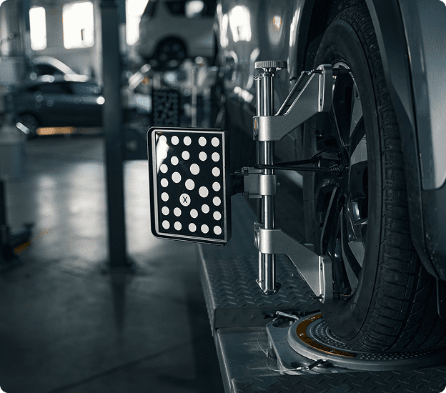 Vehicle undergoing wheel alignment check