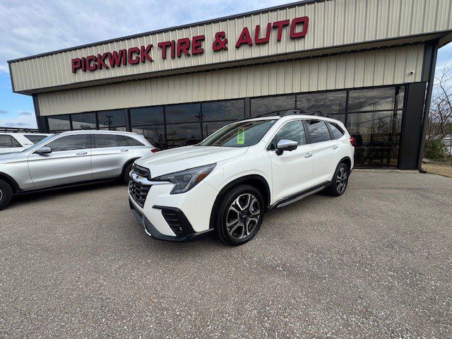 White SUV parked in front of Pickwick Tire & Auto.