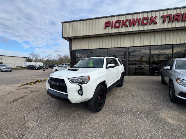 White Toyota 4Runner parked outside Pickwick dealership.